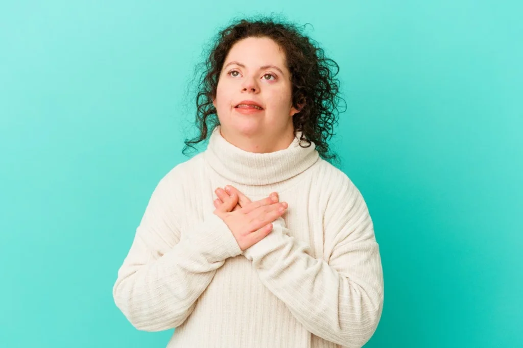 Happy disabled woman with hands on heart