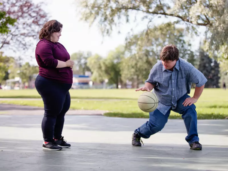 Two disabled friends playing basketball